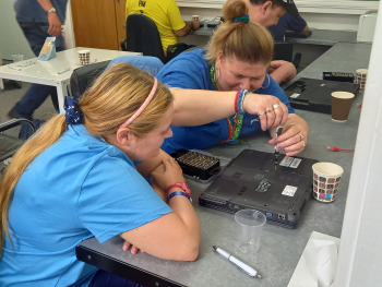 Trainees fixing a machine