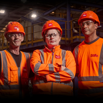 Three people who work at Biffa recycling facility dressed in high vis equipment, standing in a powerful pose like superheroes 