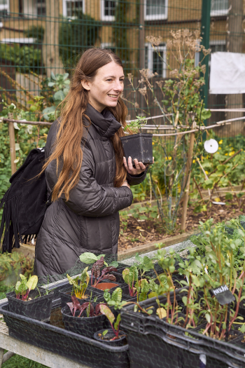 A woman holding a plant at the Harvest Festival