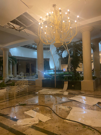 A flooded hotel lobby covered in debris