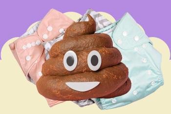 A fake poo on top of reusable nappies with a smiley face on it