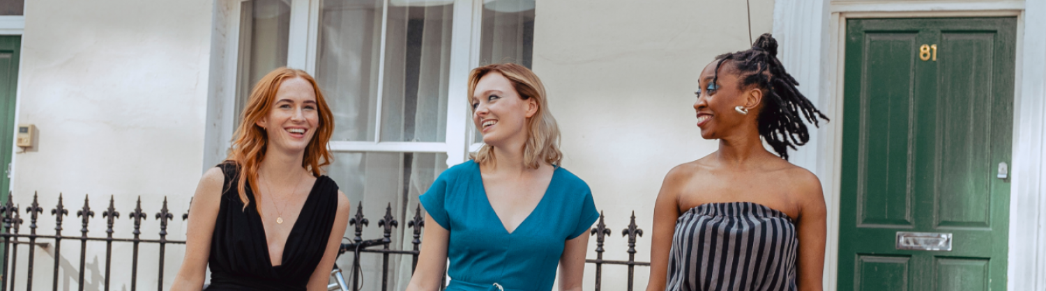 Three women wearing swapped clothes