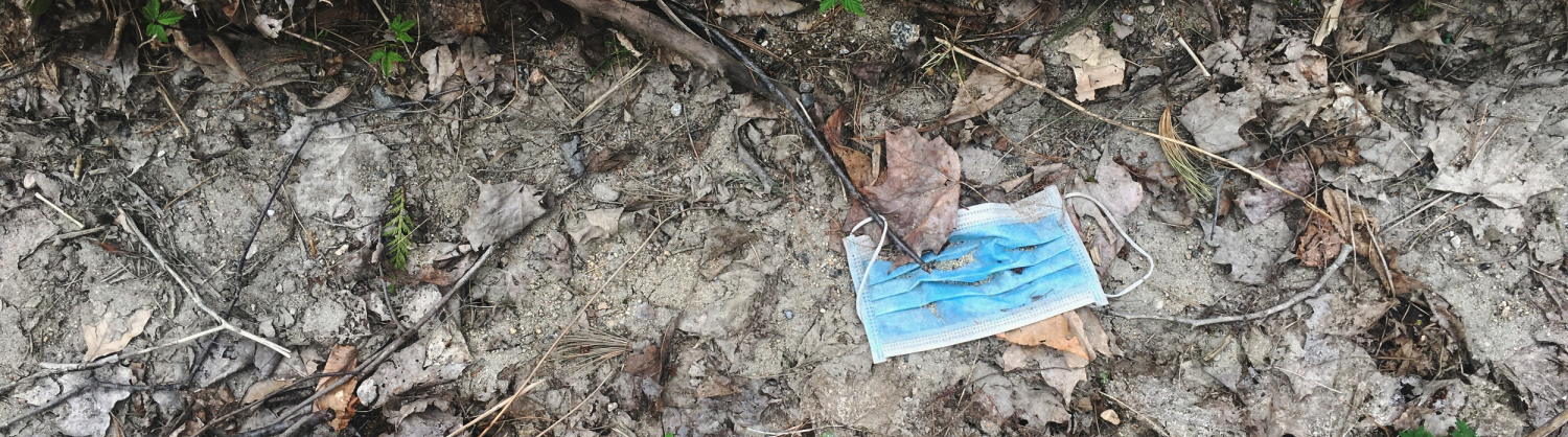 discarded facemask on floor