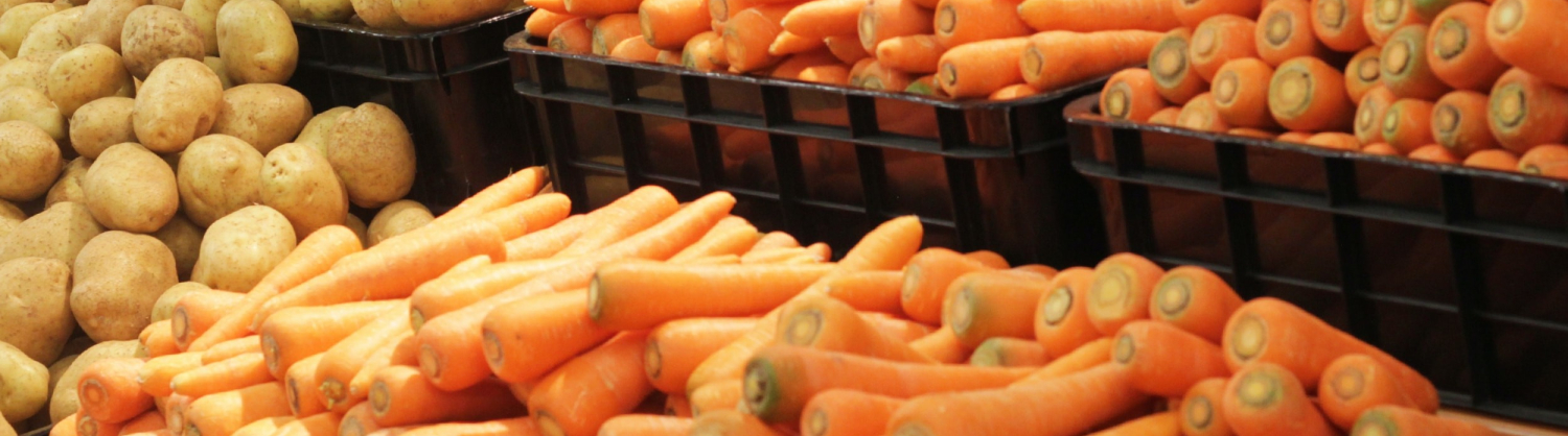 Loose carrots potatoes and bananas in the supermarket