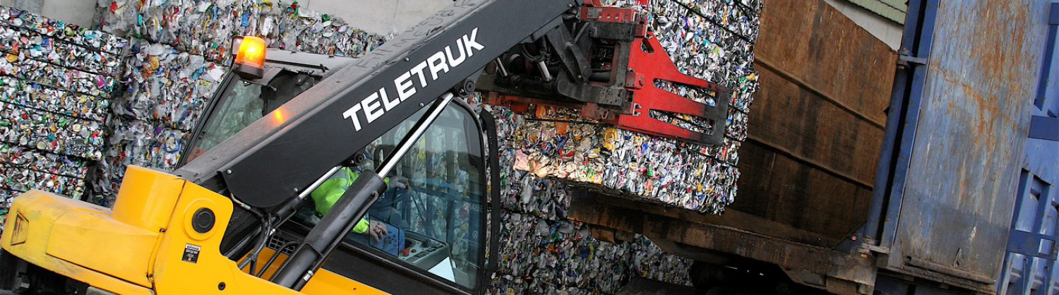 A forklift raises a bale of aluminium cans for recycling