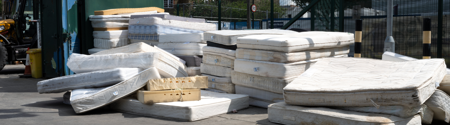 A pile of mattresses at a reuse and recycling centre