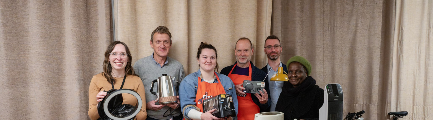 Four Camden Councillors with staff from Camden Fixing Factory presenting repaired electricals