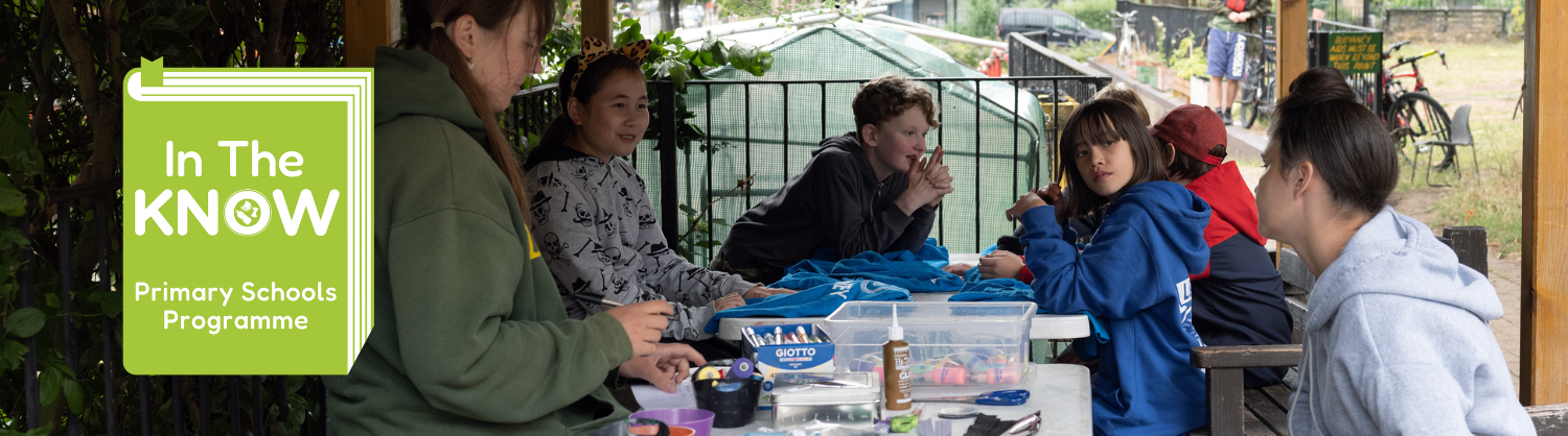 children sat around a table with the In the Know programme logo