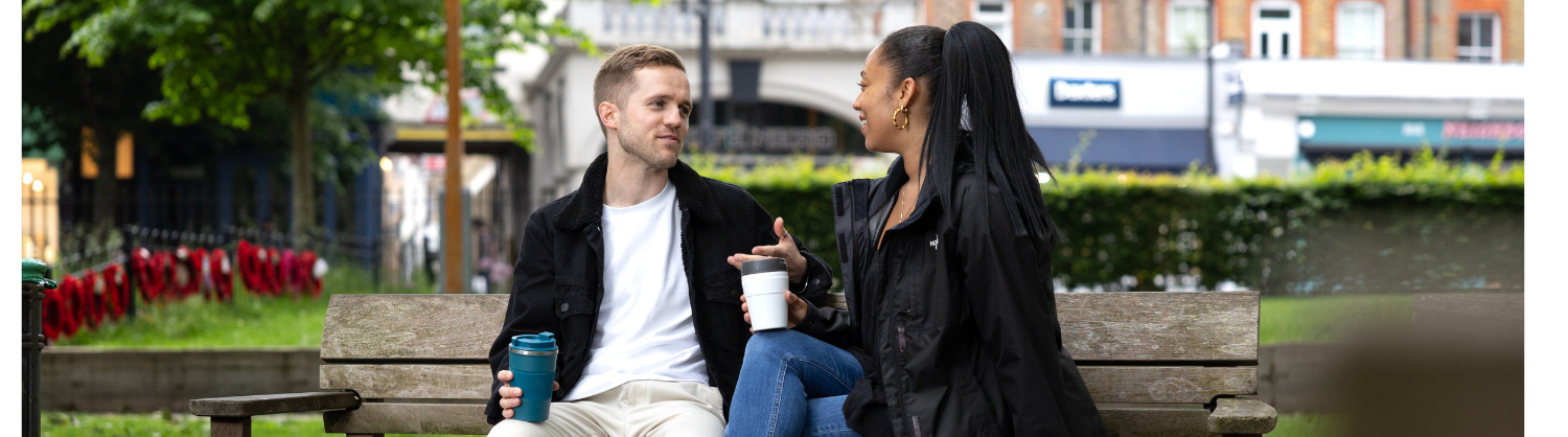 People holding reusable coffee cups
