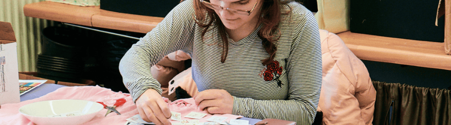 An attendee working on an art project at a Community Focus Inclusive Arts workshop