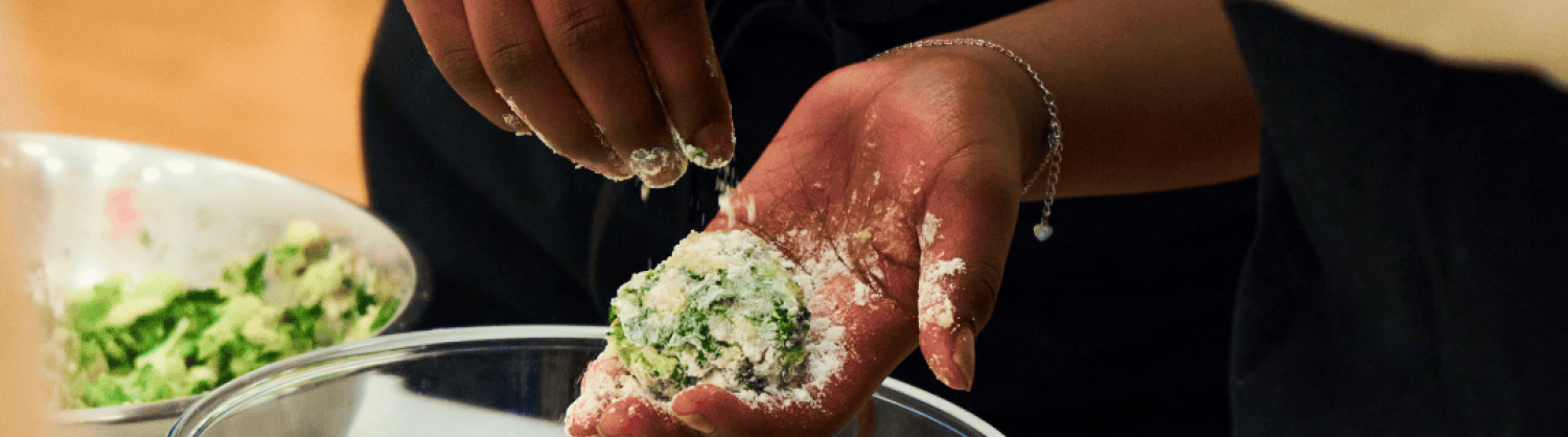 Close up of hands making food