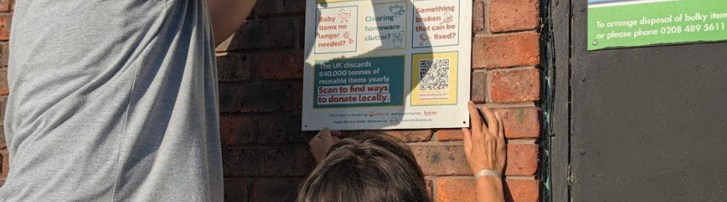 two people putting up a panel on wall