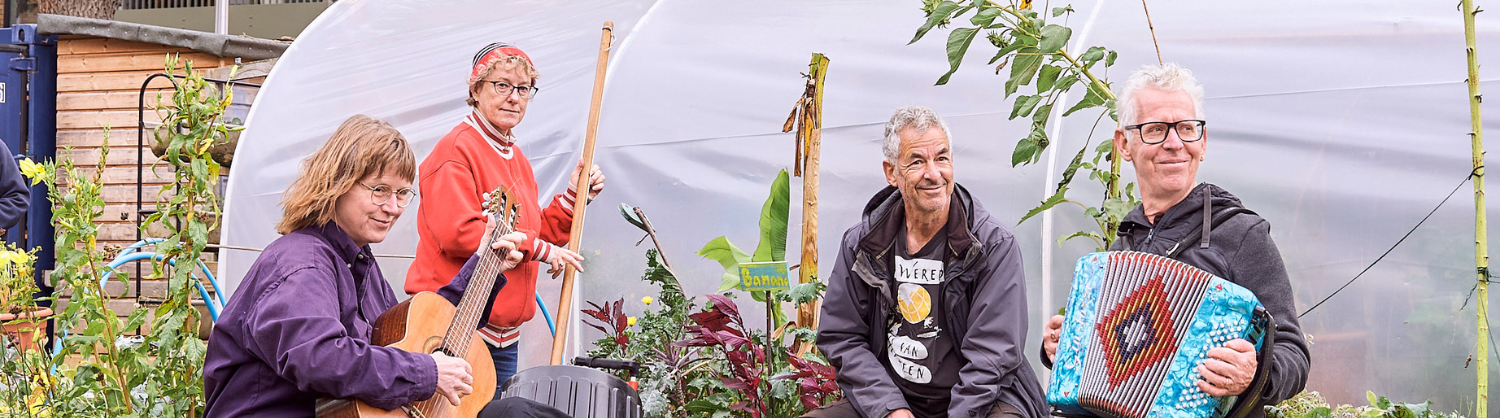 Live musicians playing in a community garden at the Octopus Harvest Festival