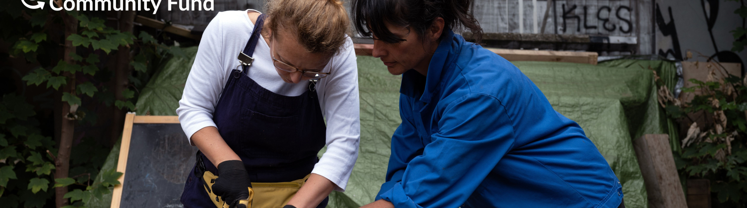 Two people working with tools together