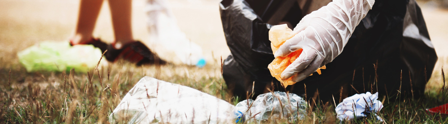 Plastic waste being placed in a bin liner