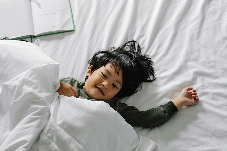 Child lying on a bed