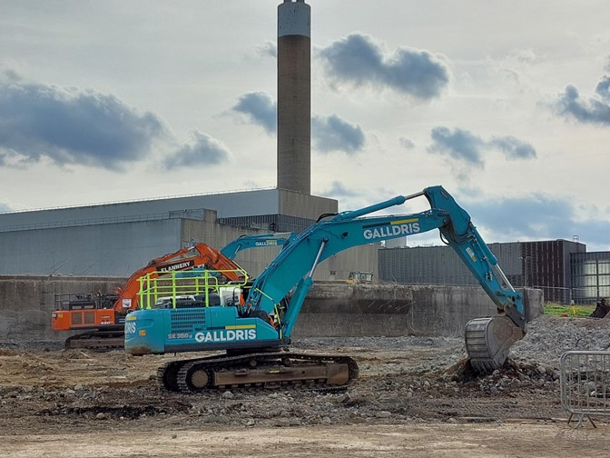 A local Enfield-based company, Galldris, is completing the first phase of the Energy Recovery Facility construction enabling works. Two excavators are clearing the site with the current energy from waste plant in the background. 