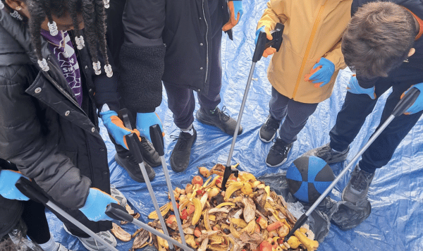Students use litter pickers to sort through food waste