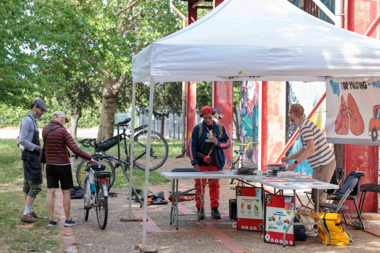 A marquee where someone is repairing a bike