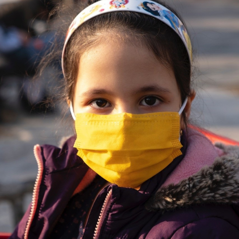 girl wearing yellow face mask
