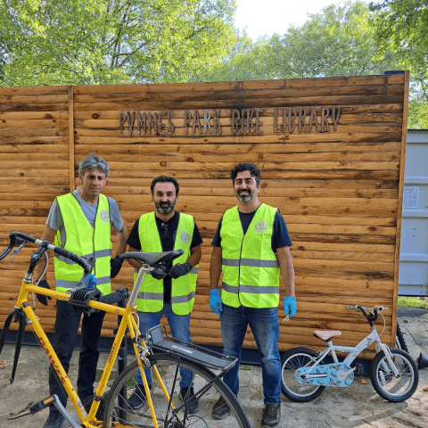 3 volunteers at a bike repair day in Pymmes Park