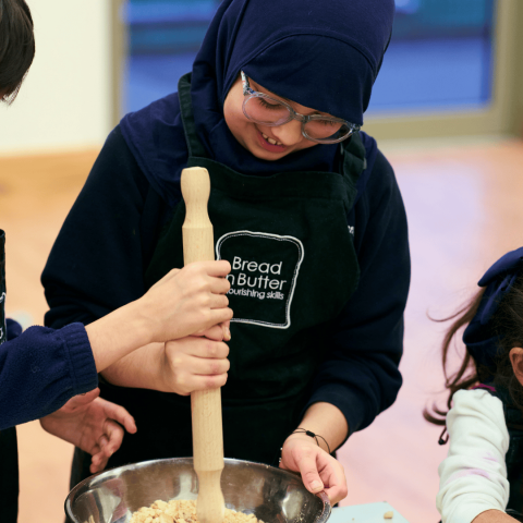Student learning how to make a dish with Bread n Butter
