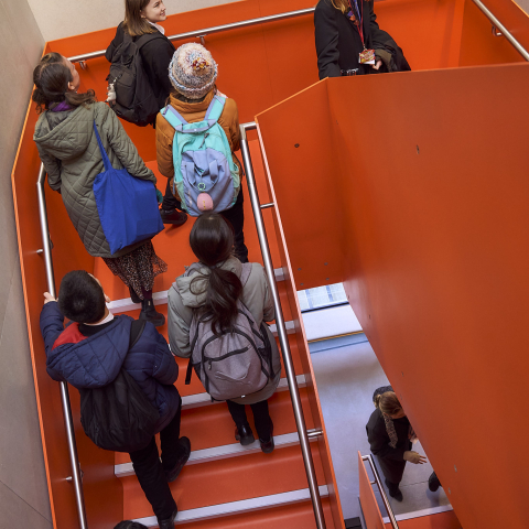 Group of students walking up the stairs at EcoPark House 