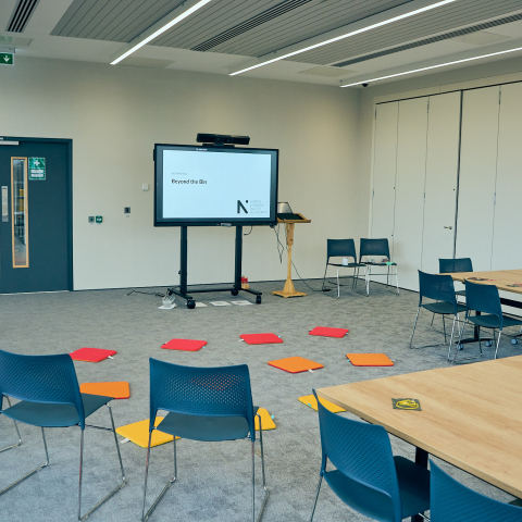Lecture hall at EcoPark House set up with tables and chairs for a school visit