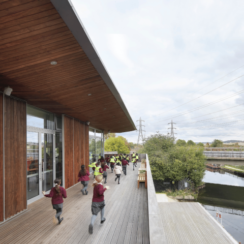Students running outside on the terrace at EcoPark House