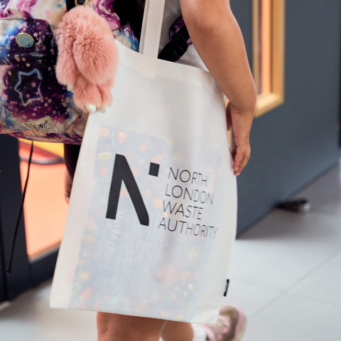 Student holding NLWA tote bag