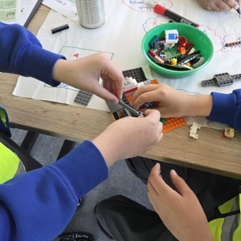 Two students building lego together