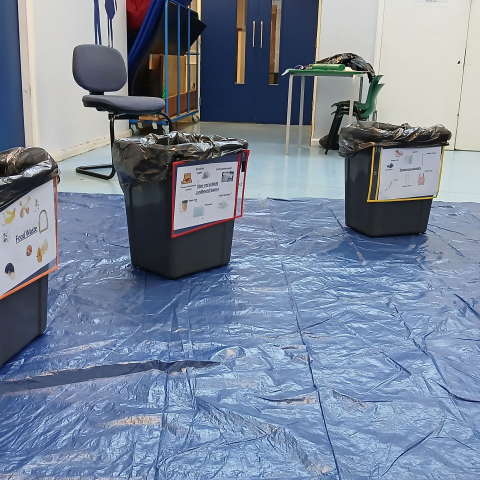 Rubbish bins on a blue tarp
