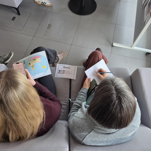 two students completing activity booklets