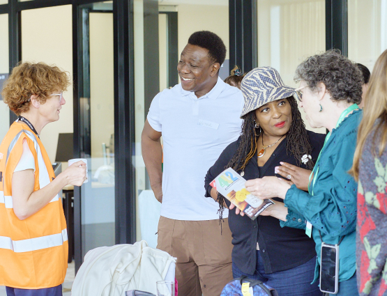 Members of community groups chatting and laughing