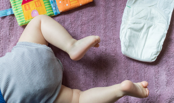 Baby crawling and nappy on floor