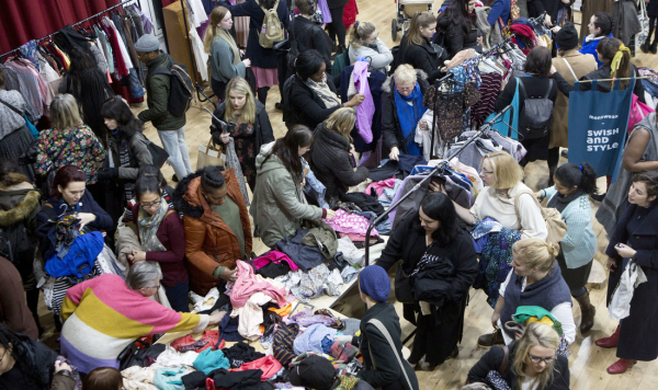 Lots of people looking at clothes at a Swish and Style event