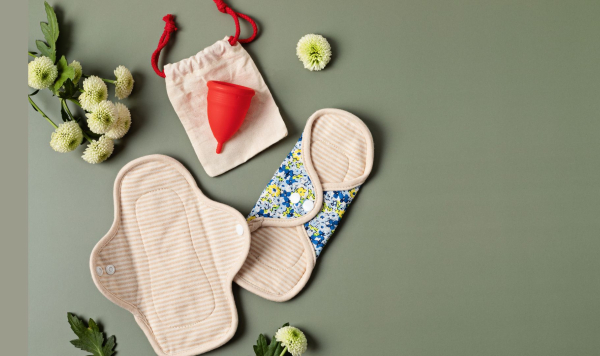 Reusable pants, cup and pads laid on top of each other