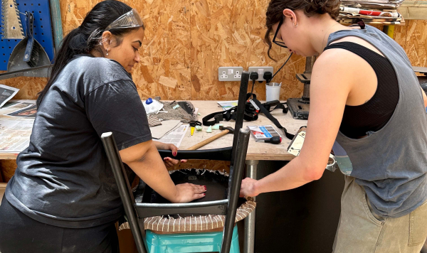 Women restoring a chair in workshop